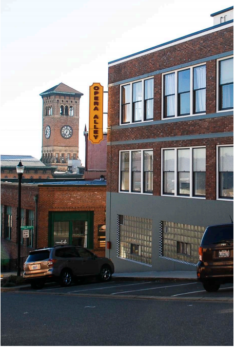 The Ledger Building on Opera Alley in downtown Tacoma, with the Old City Hall clock tower in the background